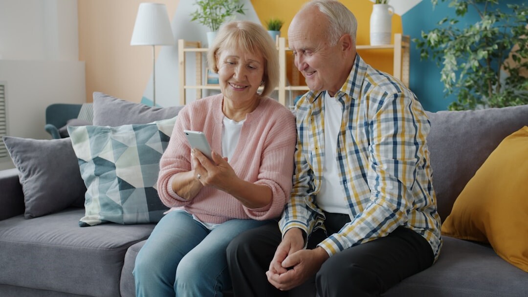 Happy senior couple looking at a tablet together at home