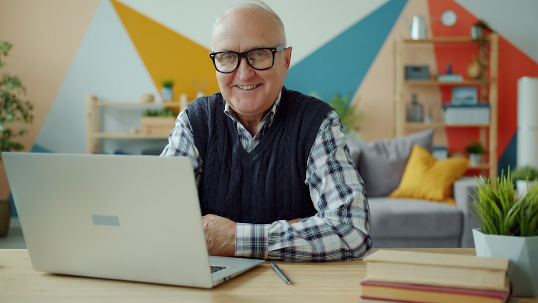 elderly man working at desk