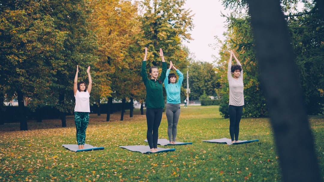 Seniors doing gentle group exercise outdoors in a park